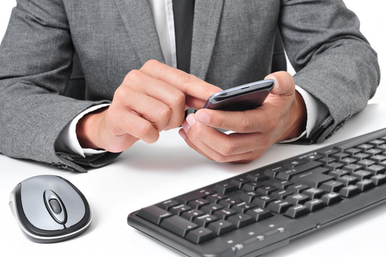 photodune-8463508-businessman-using-a-smartphone-in-the-office-xs.jpg