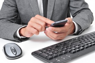 b2ap3 small photodune 8463508 businessman using a smartphone in the office xs