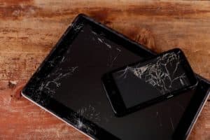 broken, cracked tablet and phone were damaged by an IT disaster