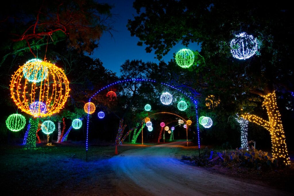 Winter light fest with hanging ornaments on trees