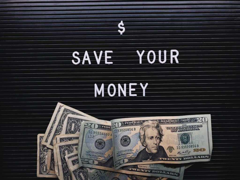 save your money sign with cash below it