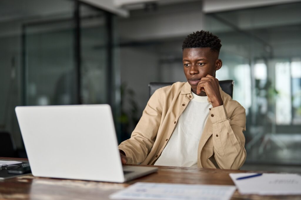 man working on laptop computer at office